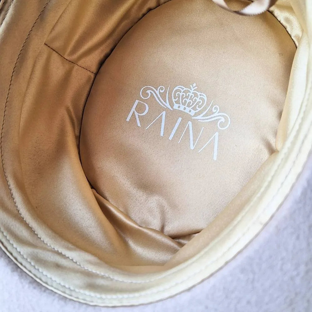 Inside of beige beauty wool boater hat with gold satin lining.