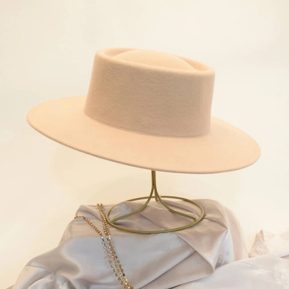 Left side view of beige beauty satin lined wool boater hat.