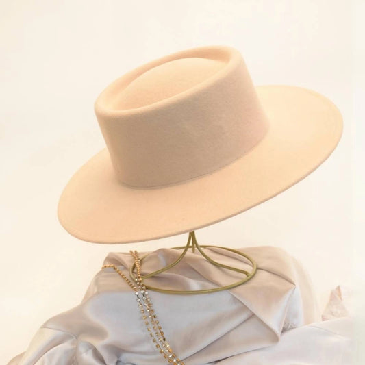 Side view of beige beauty satin lined wool boater hat.