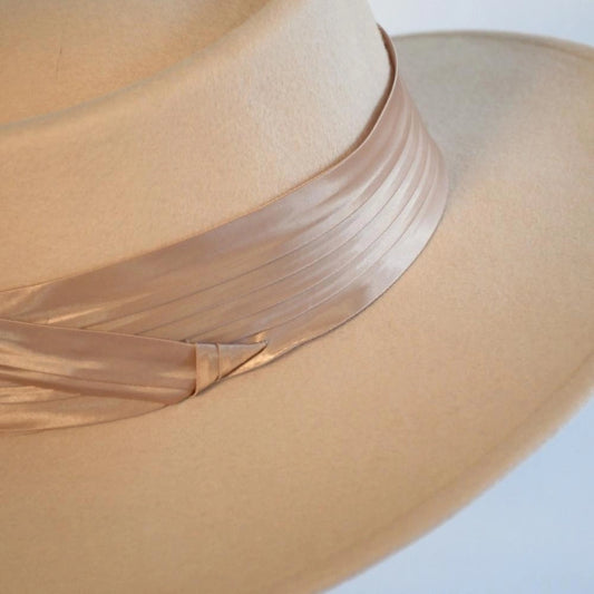 Another close up side view of the beige beauty boater hat with the caramel satin hat band.