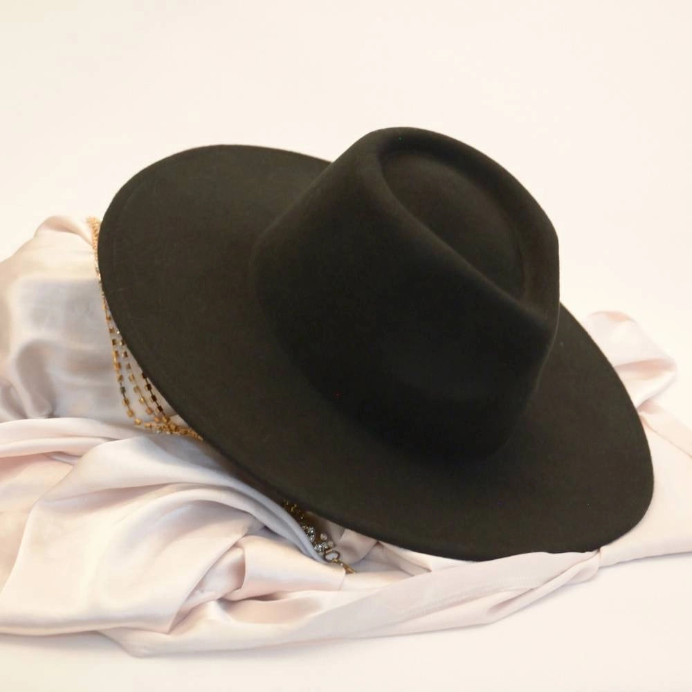 Ebony crown satin lined fedora on table.