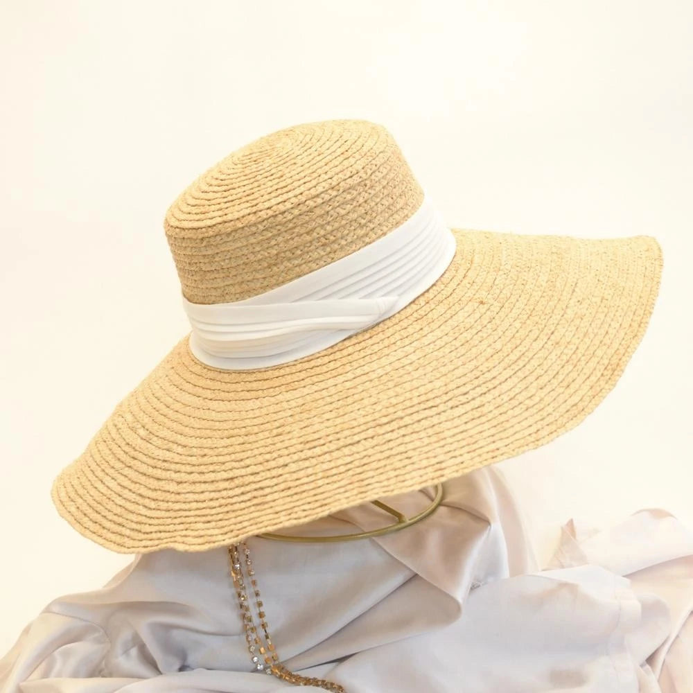 A side view of the pearl white hat band on the raffia straw satin lined hat.