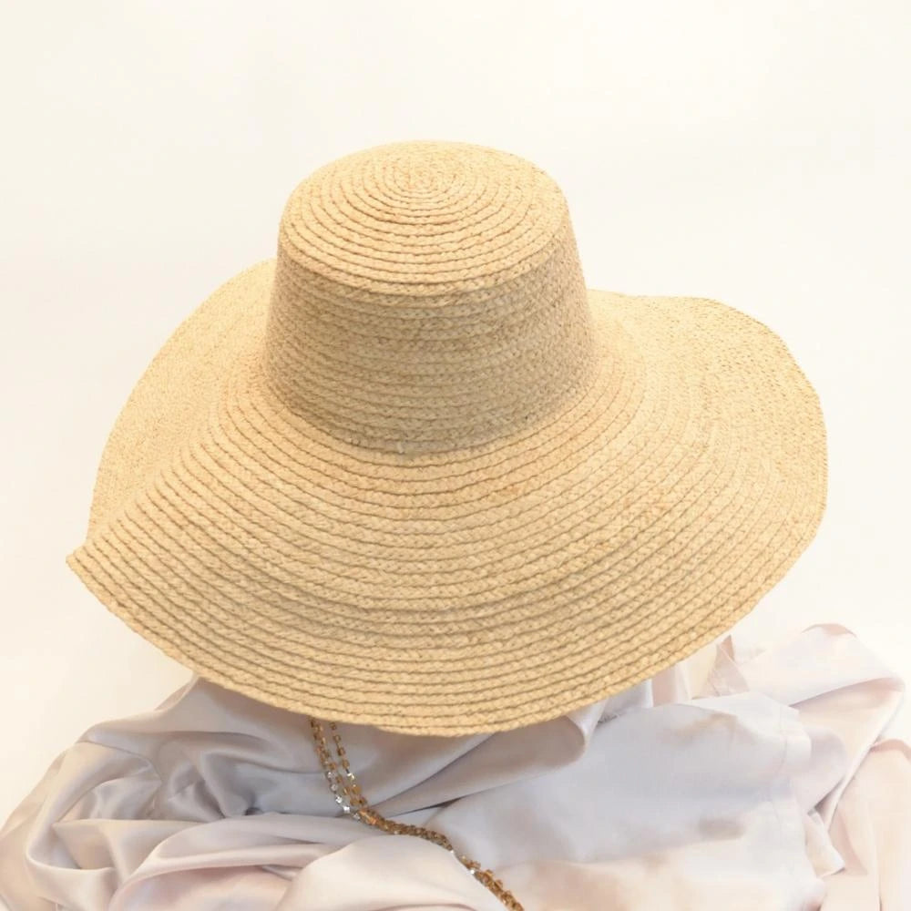 Back view of sunlit dream satin lined wide brimmed raffia sun beach hat.